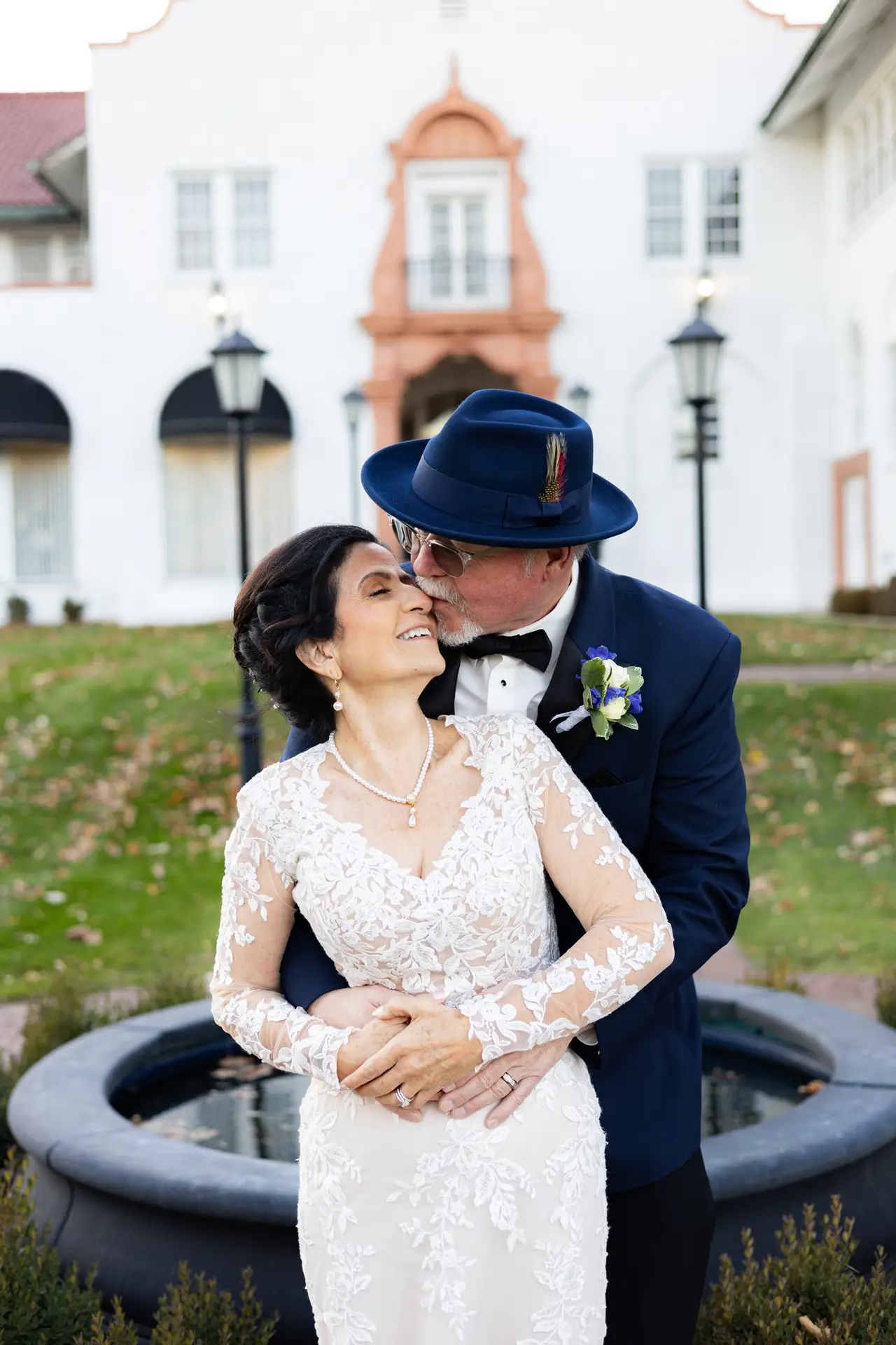 man kissing a woman that is wearing a wedding dress