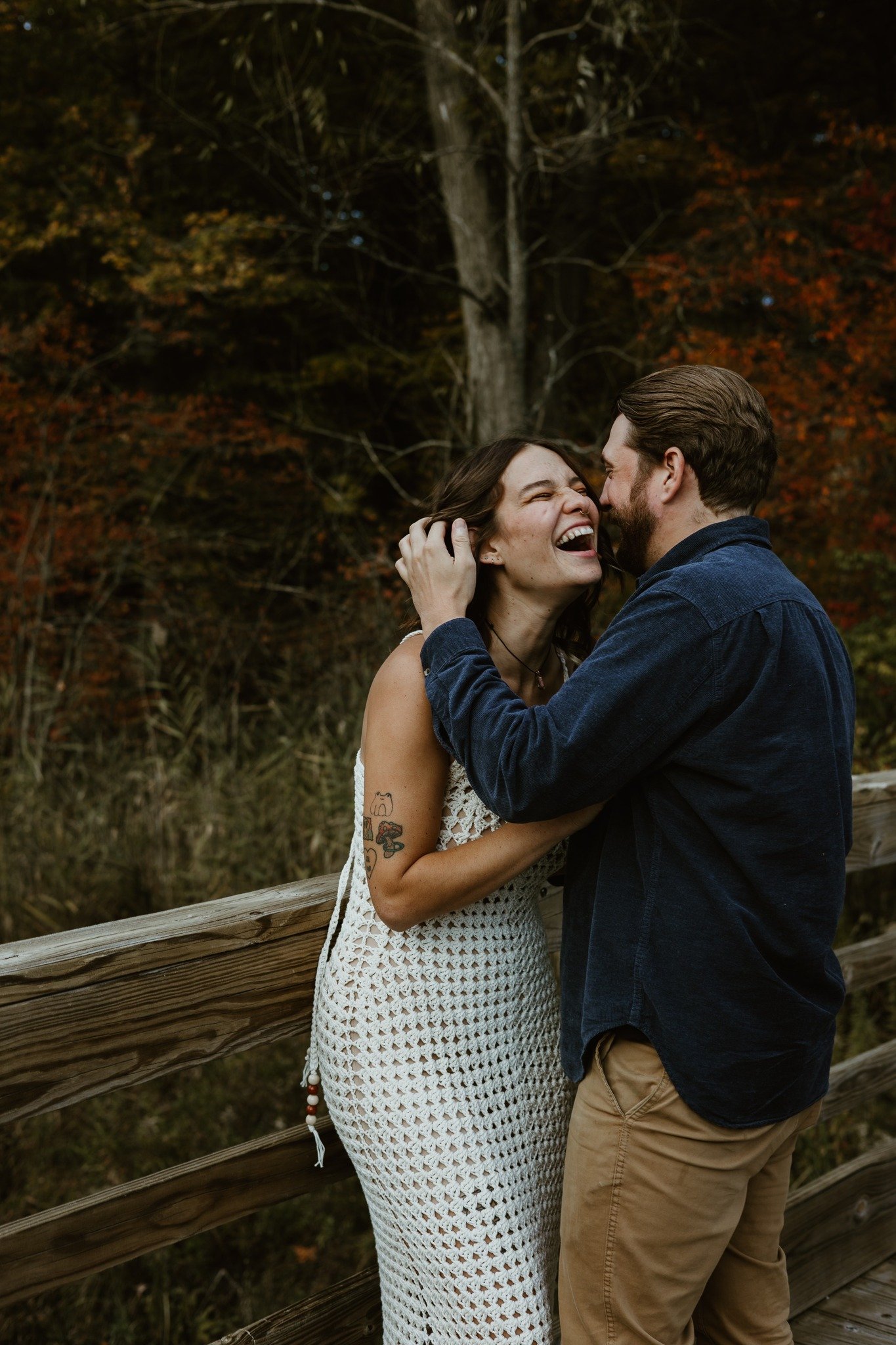 couple posing on a bridge
