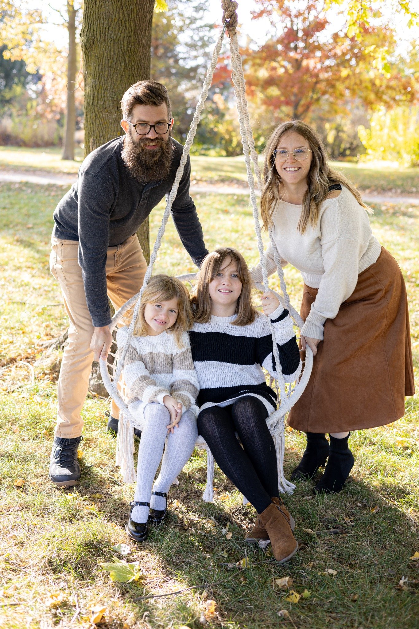 Parent swinging their children on a swing