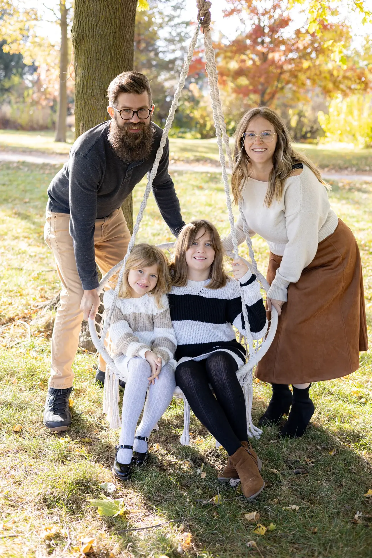 Parent swinging their children on a swing